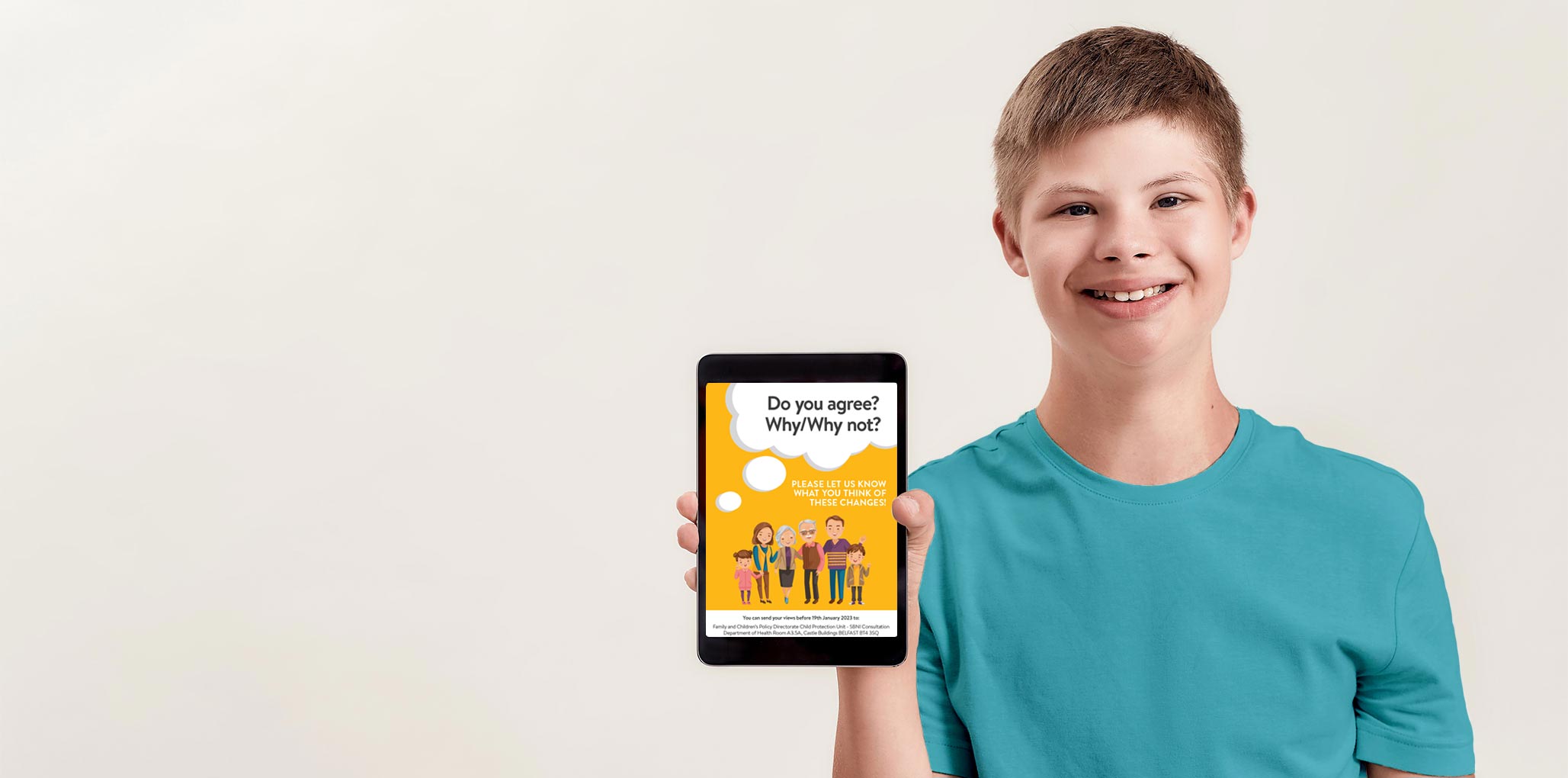 photograph of a young man holding up a tablet computer